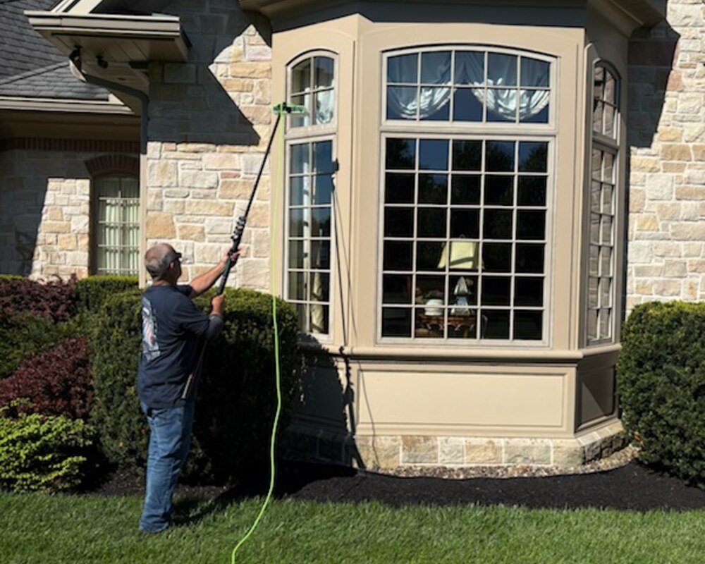 John Hinkle cleaning windows with a pure-water pole system